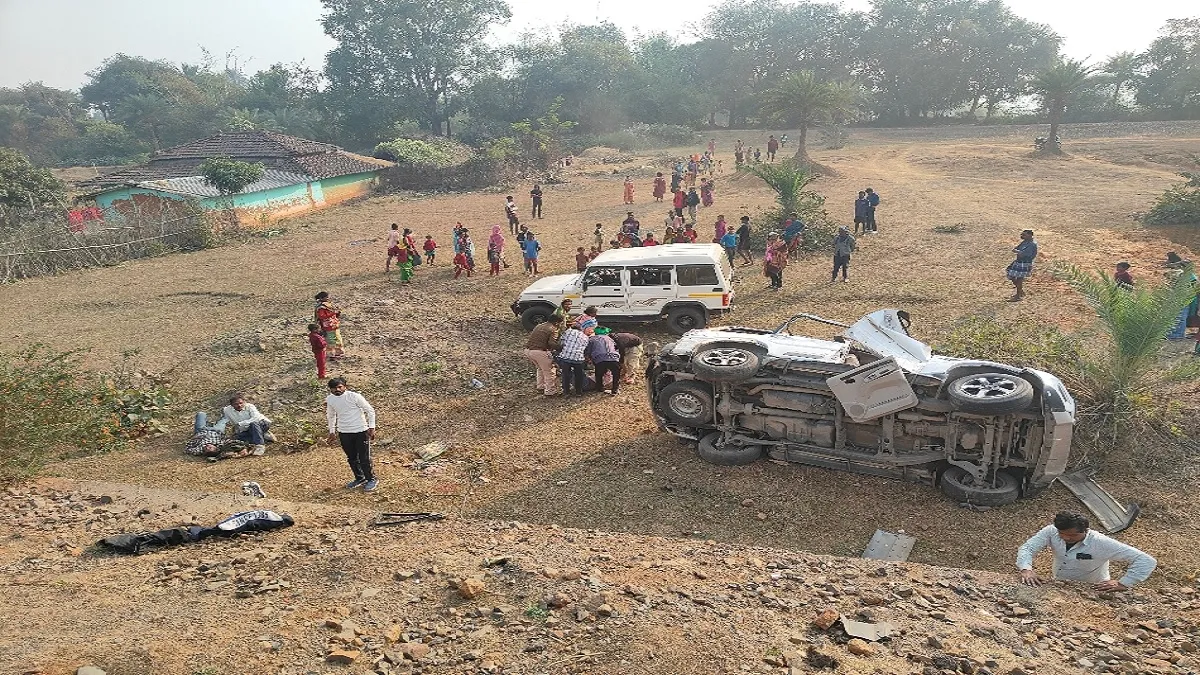 Overturned vehicle with bystanders nearby